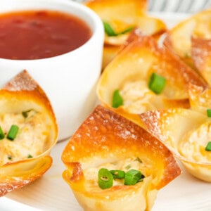 baked crab rangoon bites next to dipping sauce