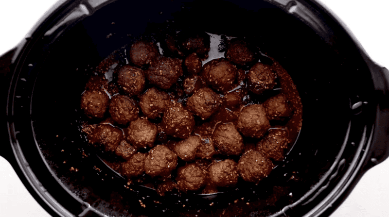 cooked saucy meatballs in a crockpot.