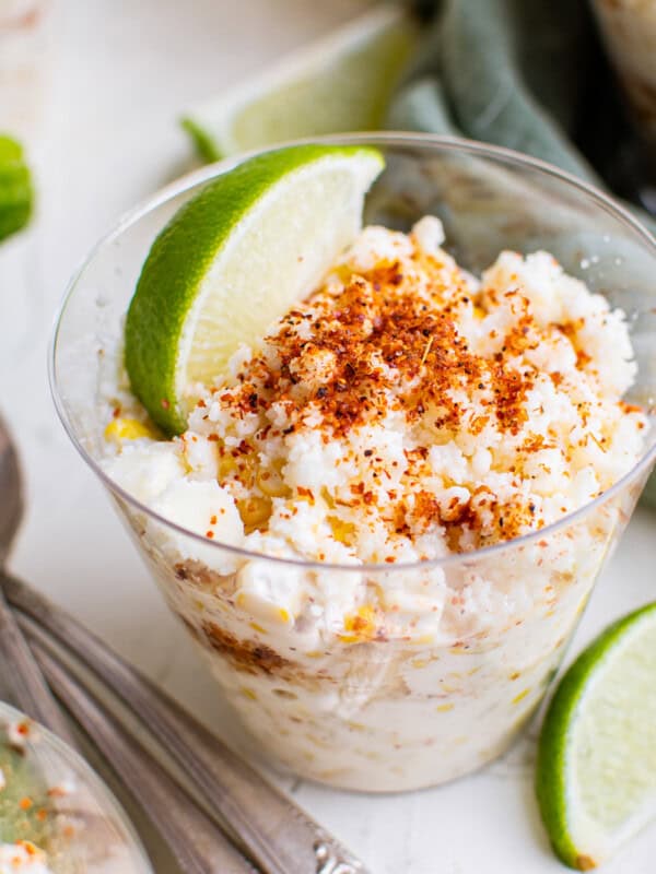 esquites in cups garnished with lime