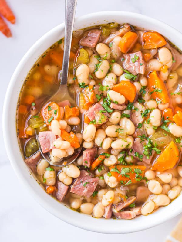 spoon in bowl of instant pot ham and bean soup