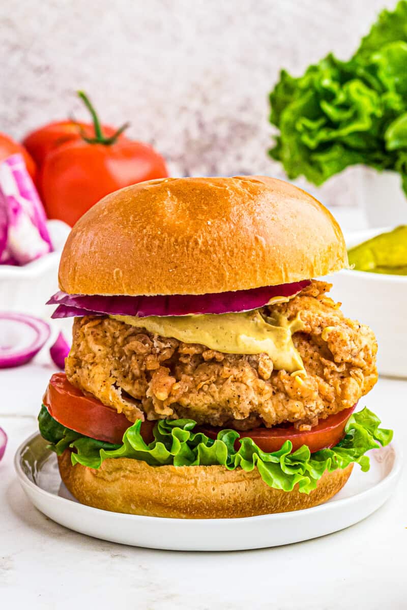 crispy chicken sandwich with bun on white table