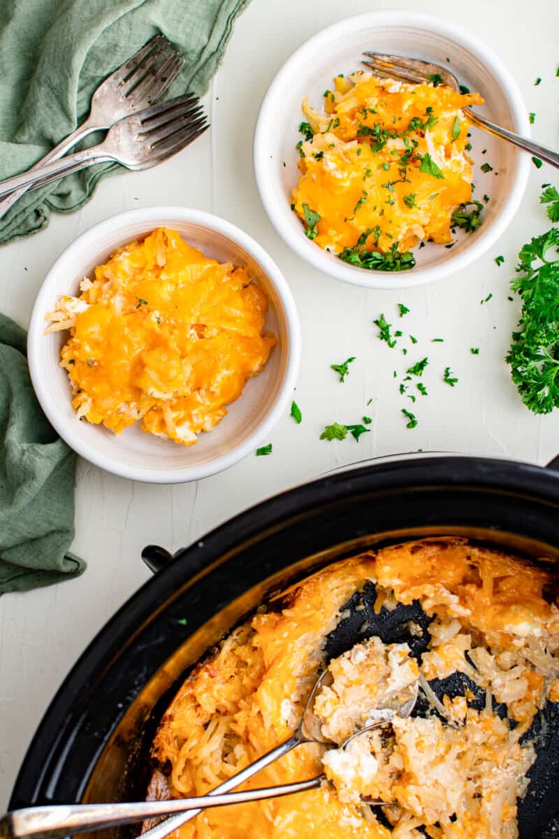 crockpot cheesy hashbrowns next to bowls