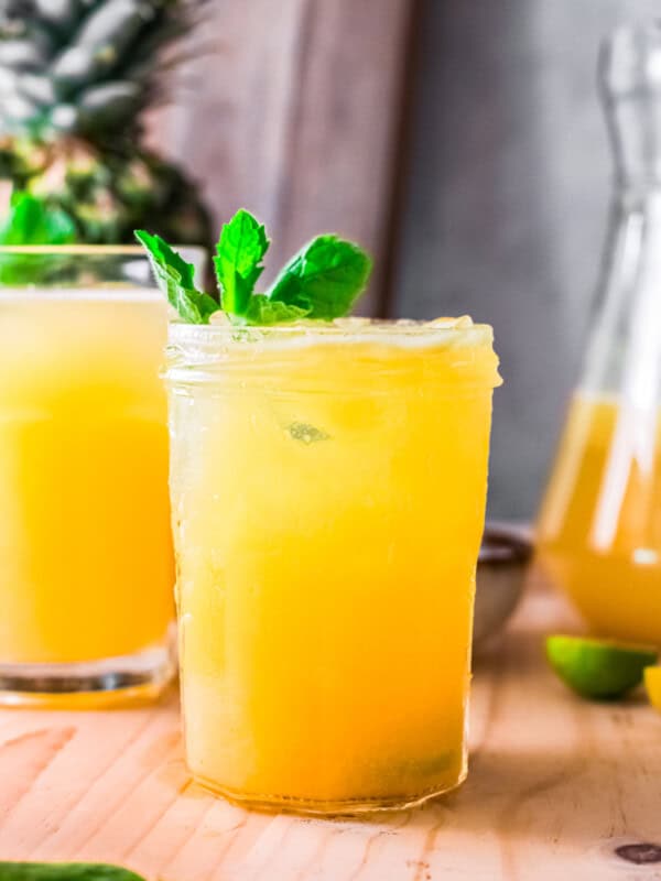 pineapple agua fresca in glass garnished with mint