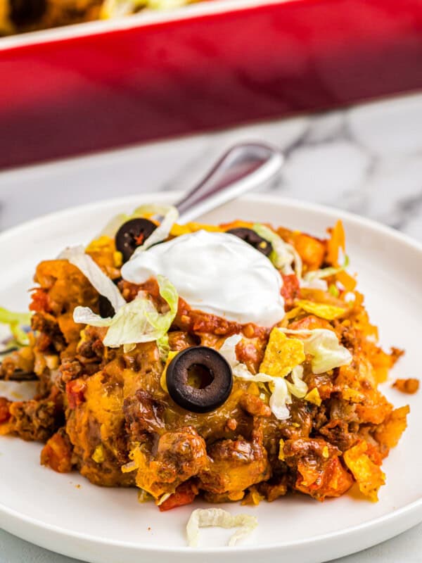 taco casserole on plate garnished with sour cream