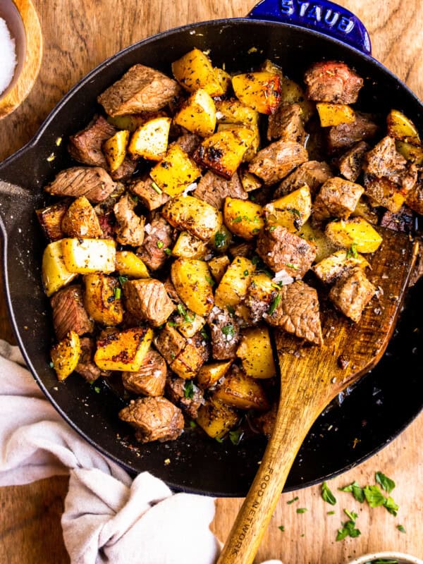 garlic butter steak bites with potatoes in skillet