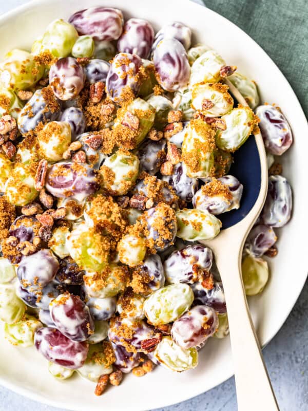 white bowl with grape salad and ceramic spoon