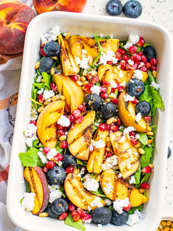 overhead grilled peach salad in white serving dish