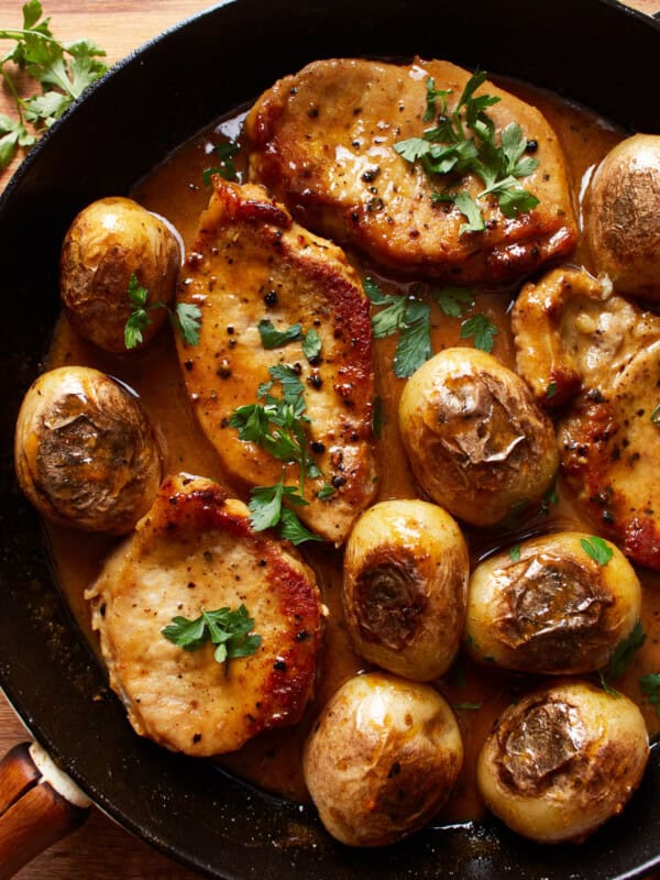 overhead view of honey mustard pork chops and potatoes in a skillet.