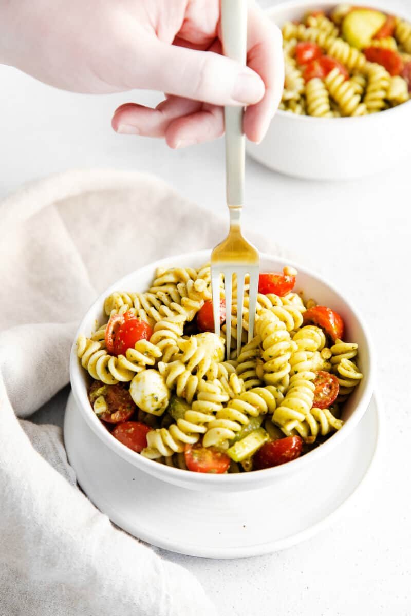 fork digging into pesto pasta salad