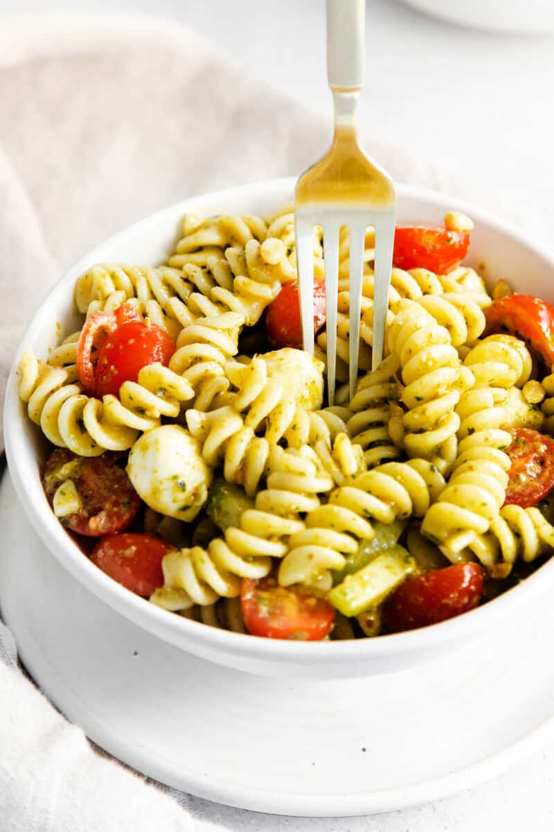 fork digging into pesto pasta salad