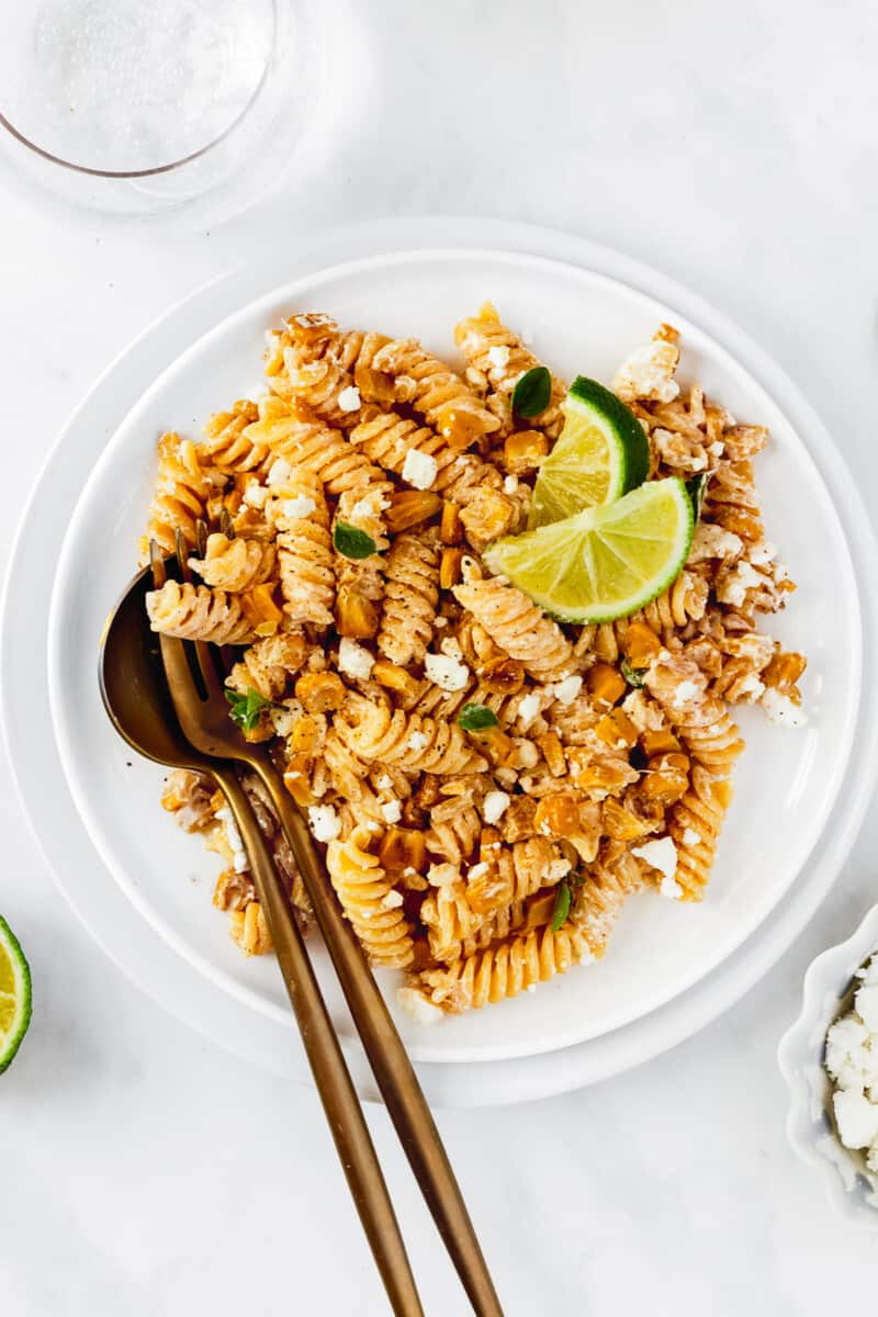 white plate with mexican street corn pasta salad