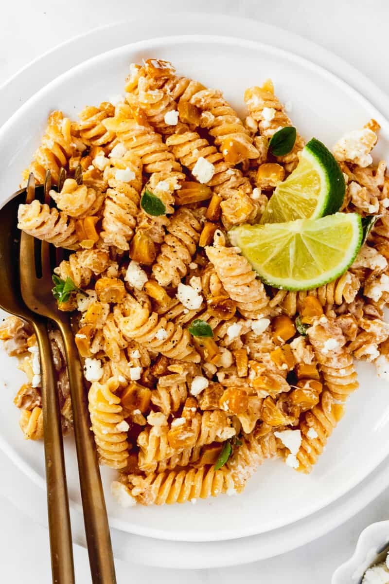 up close white plate with mexican street corn pasta salad