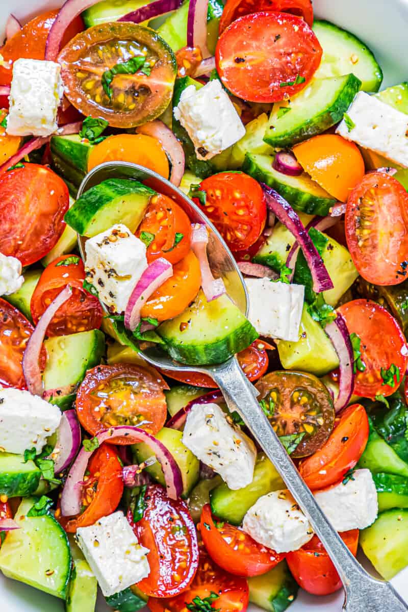 spoon in cucumber tomato salad