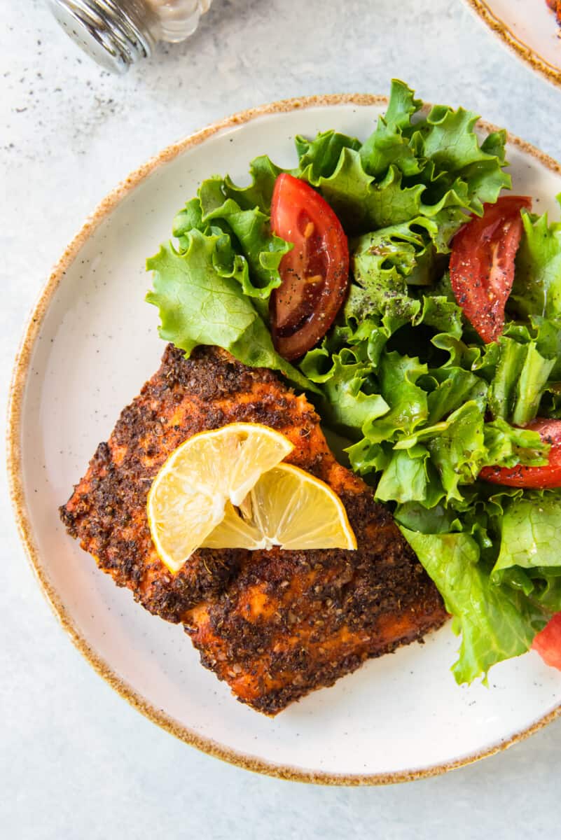 air fried salmon on plate with salad