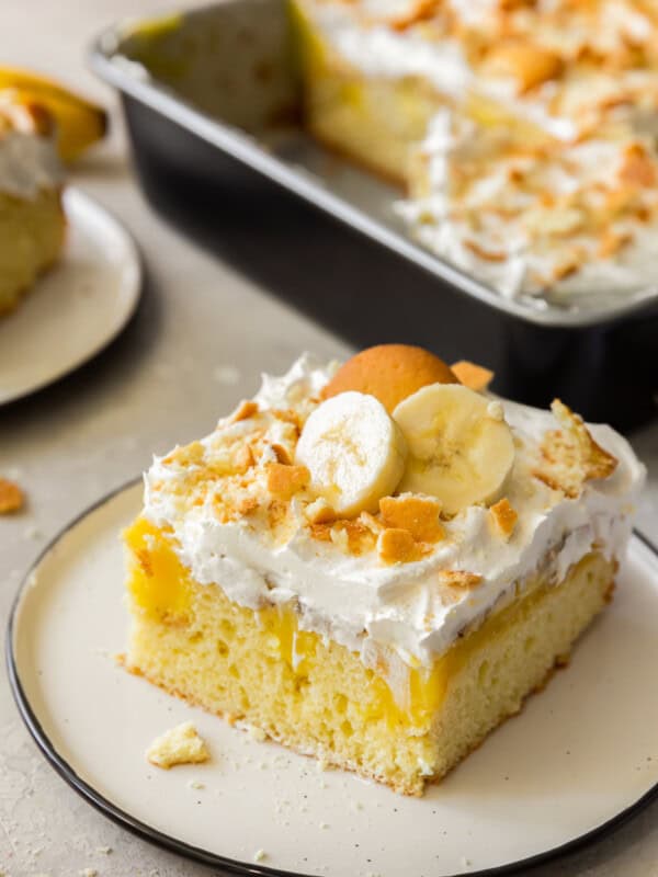 slice of banana pudding poke cake with vanilla wafers