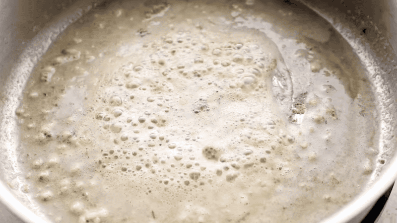 simmering garlic in butter in a pan.