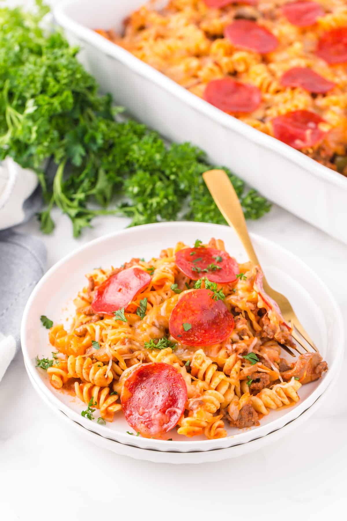 bowl of pizza casserole with pepperonis