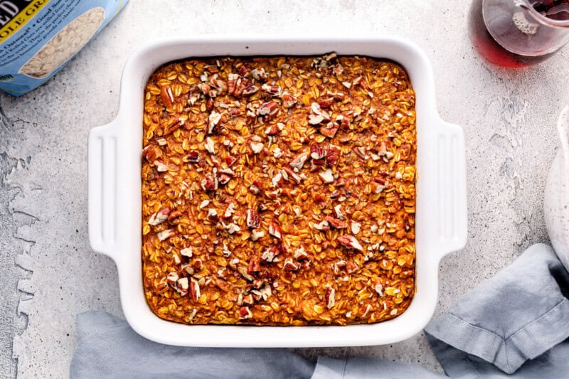 pumpkin pie baked oatmeal in a baking dish with pecans.