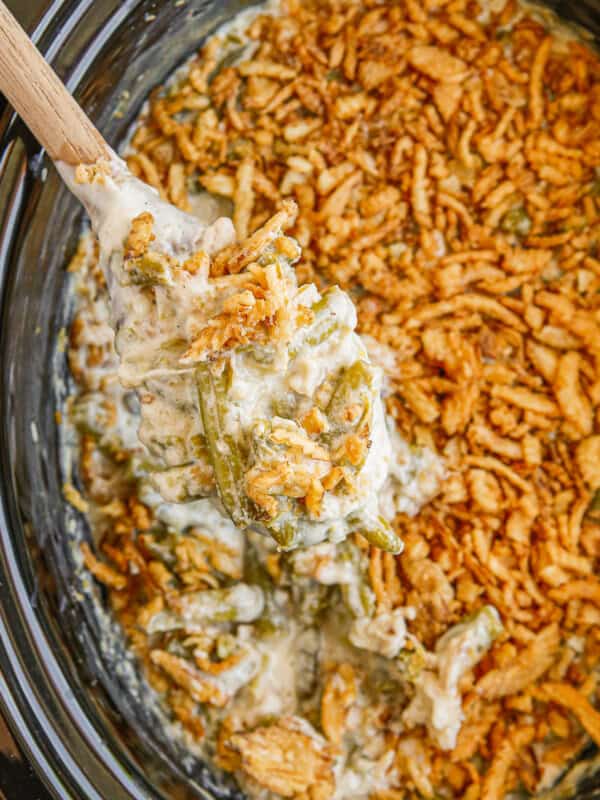 overhead wooden spoon in crockpot green bean casserole