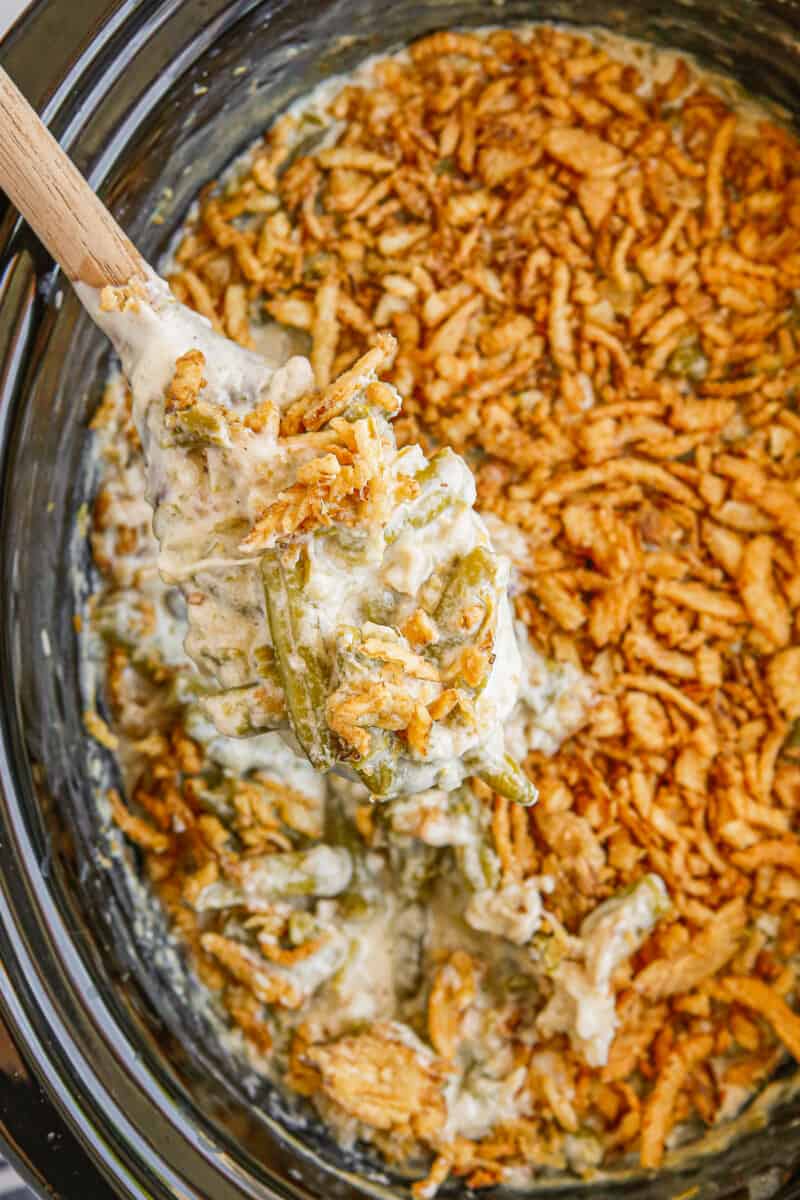 overhead wooden spoon in crockpot green bean casserole