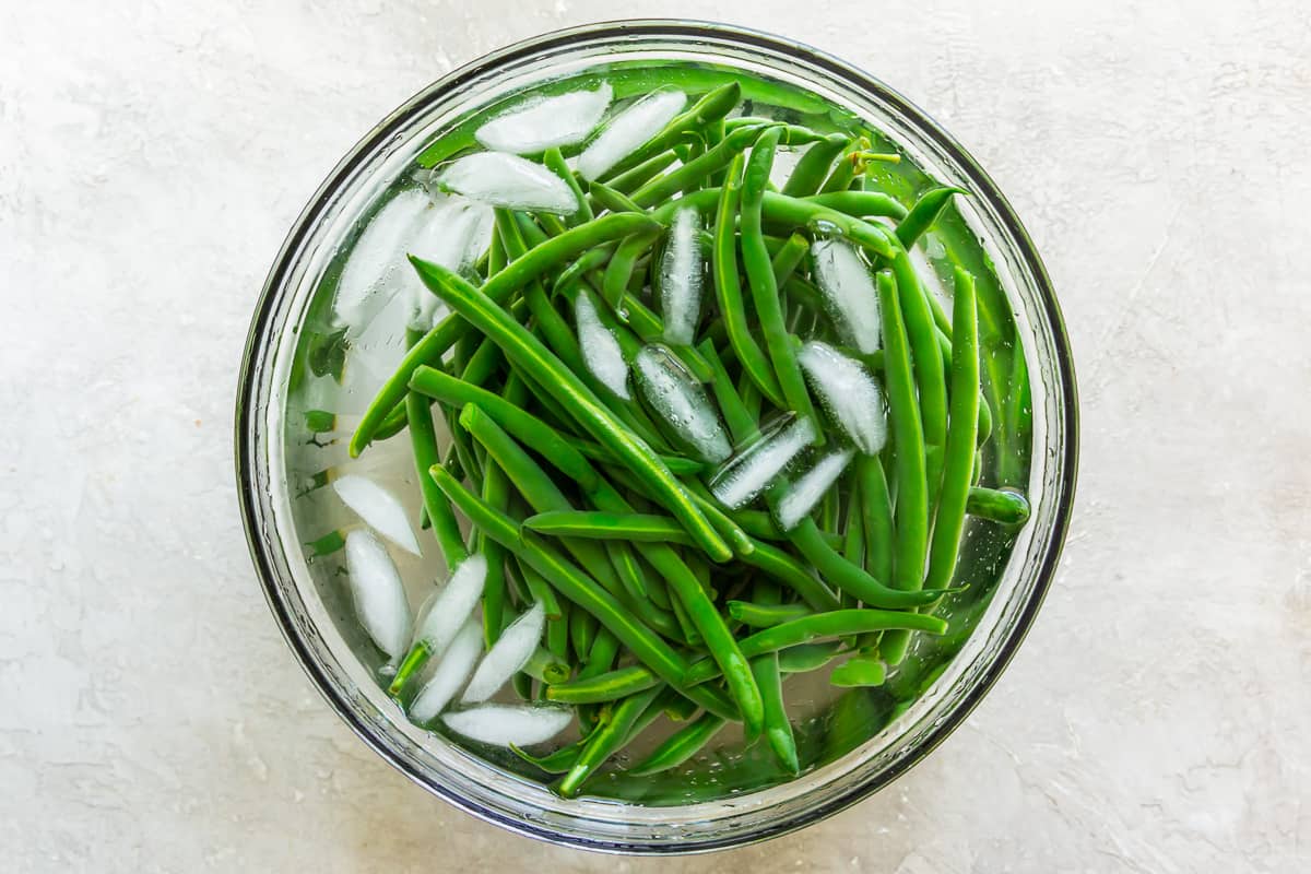 blanched green beans in ice water.