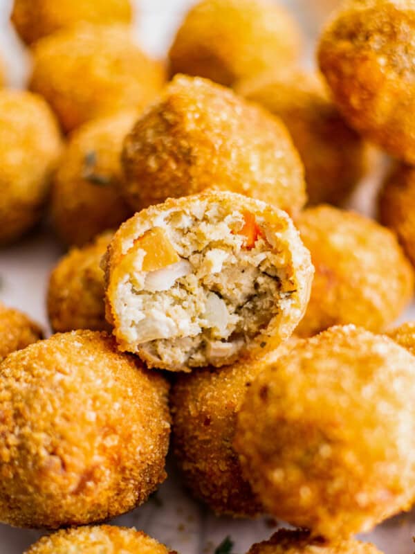 up close inside of turkey croquette cut in half on top of full croquettes