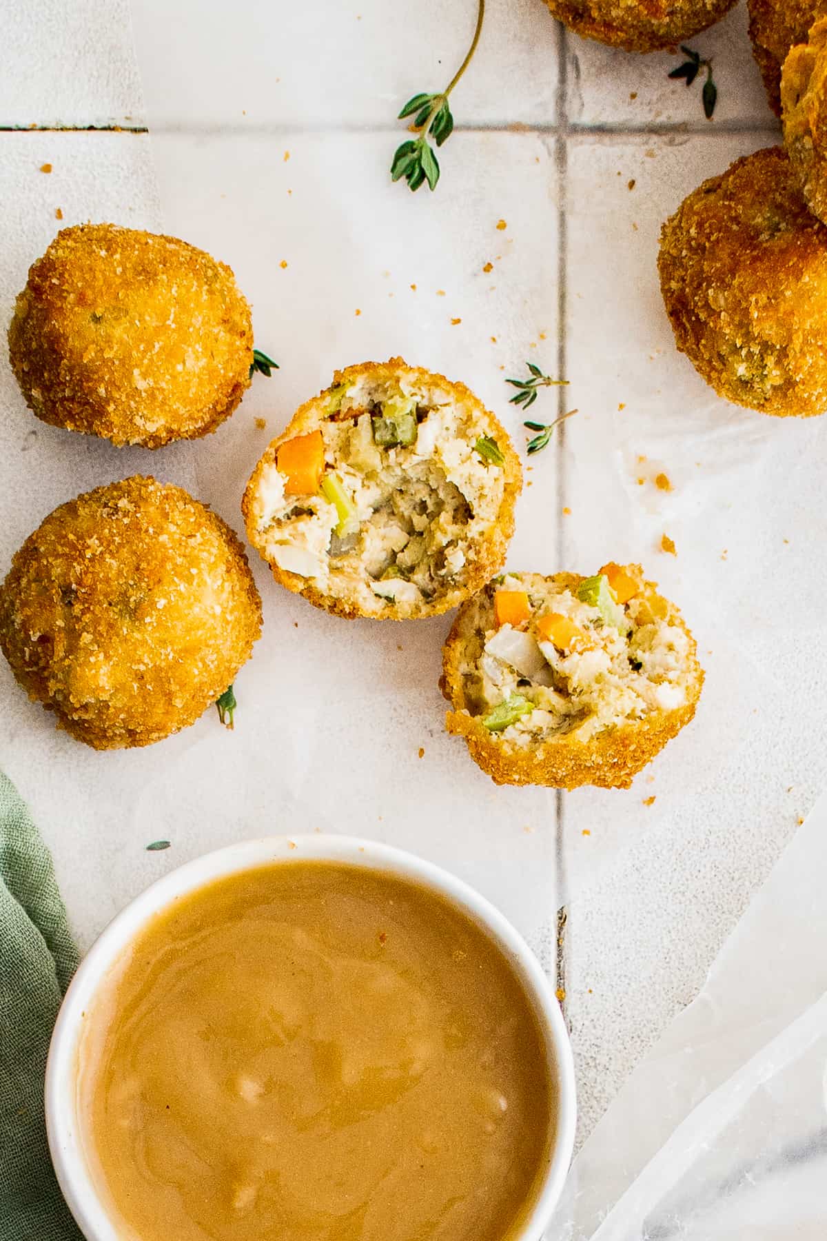 turkey croquettes on white table with gravy