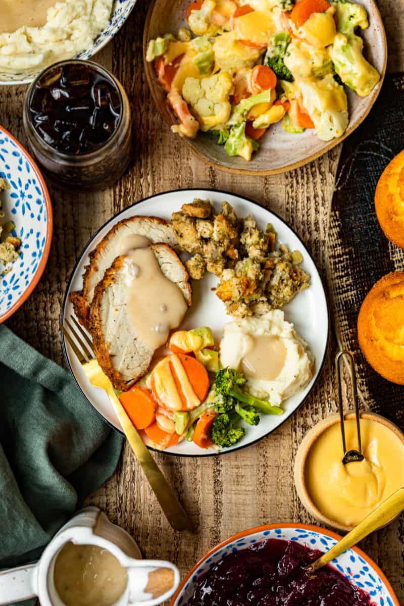 plate with thanksgiving sides and cheesy roasted vegetables