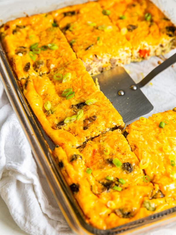 sausage breakfast casserole cut into squares with a spatula