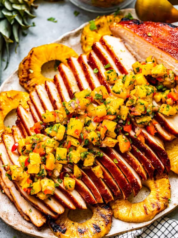 sliced huli huli turkey breast topped with pineapple salsa on a serving platter