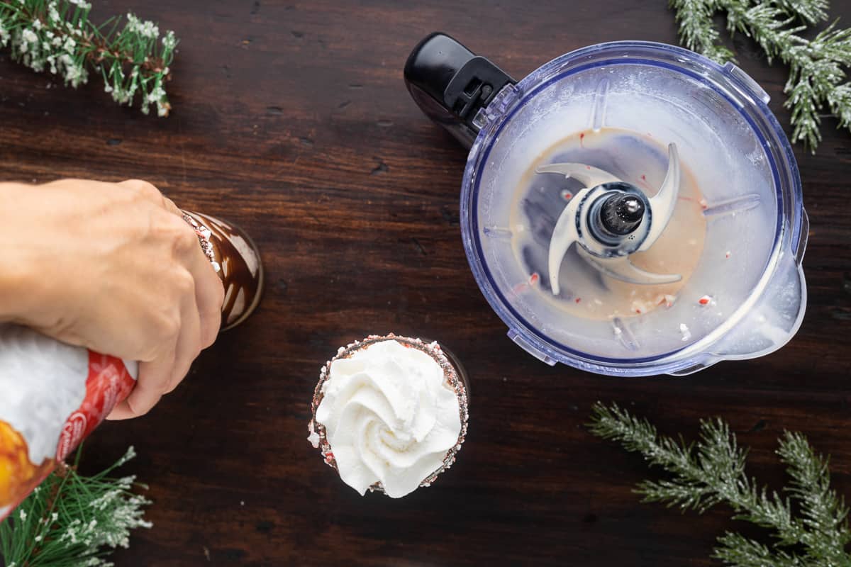 Topping off glasses with whipped cream.