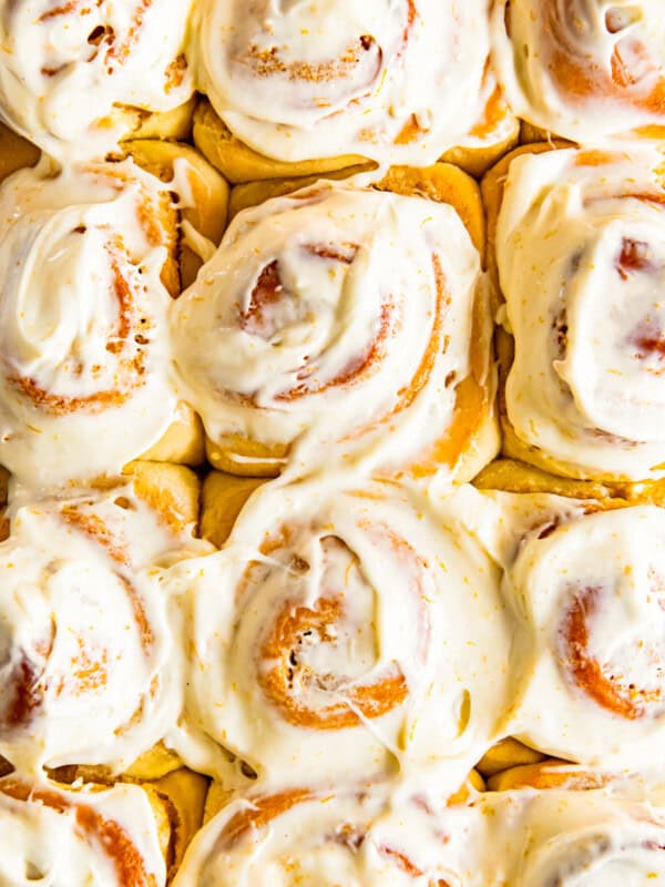 frosted orange rolls in baking dish