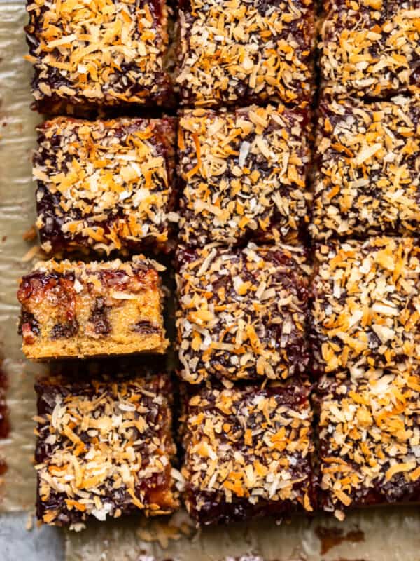 overhead image of raspberry chocolate coconut bars on parchment paper