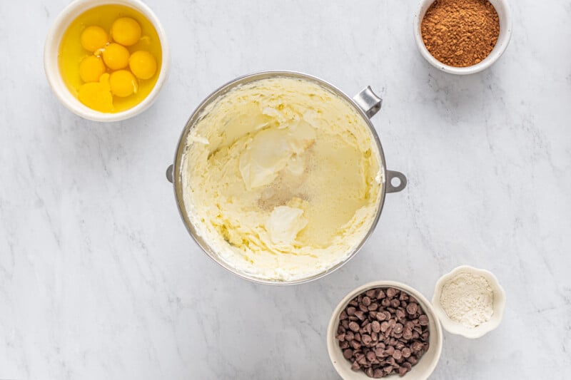 creamed cream cheese, sugar, heavy cream, sour cream, and vanilla in a metal bowl