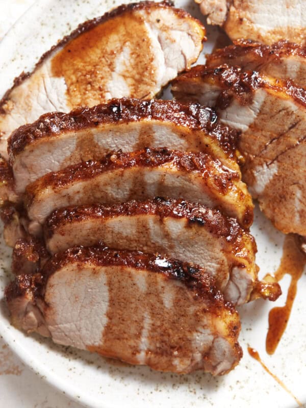 baked pork tenderloin on a white plate.