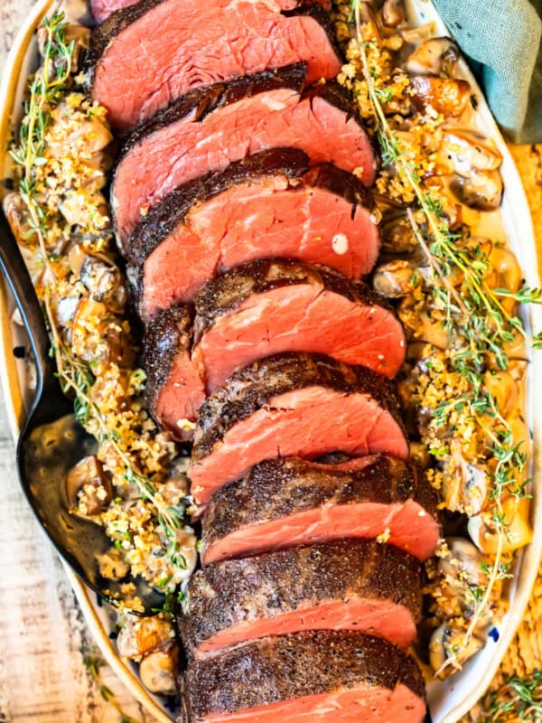 slices of beef tenderloin on a white serving platter