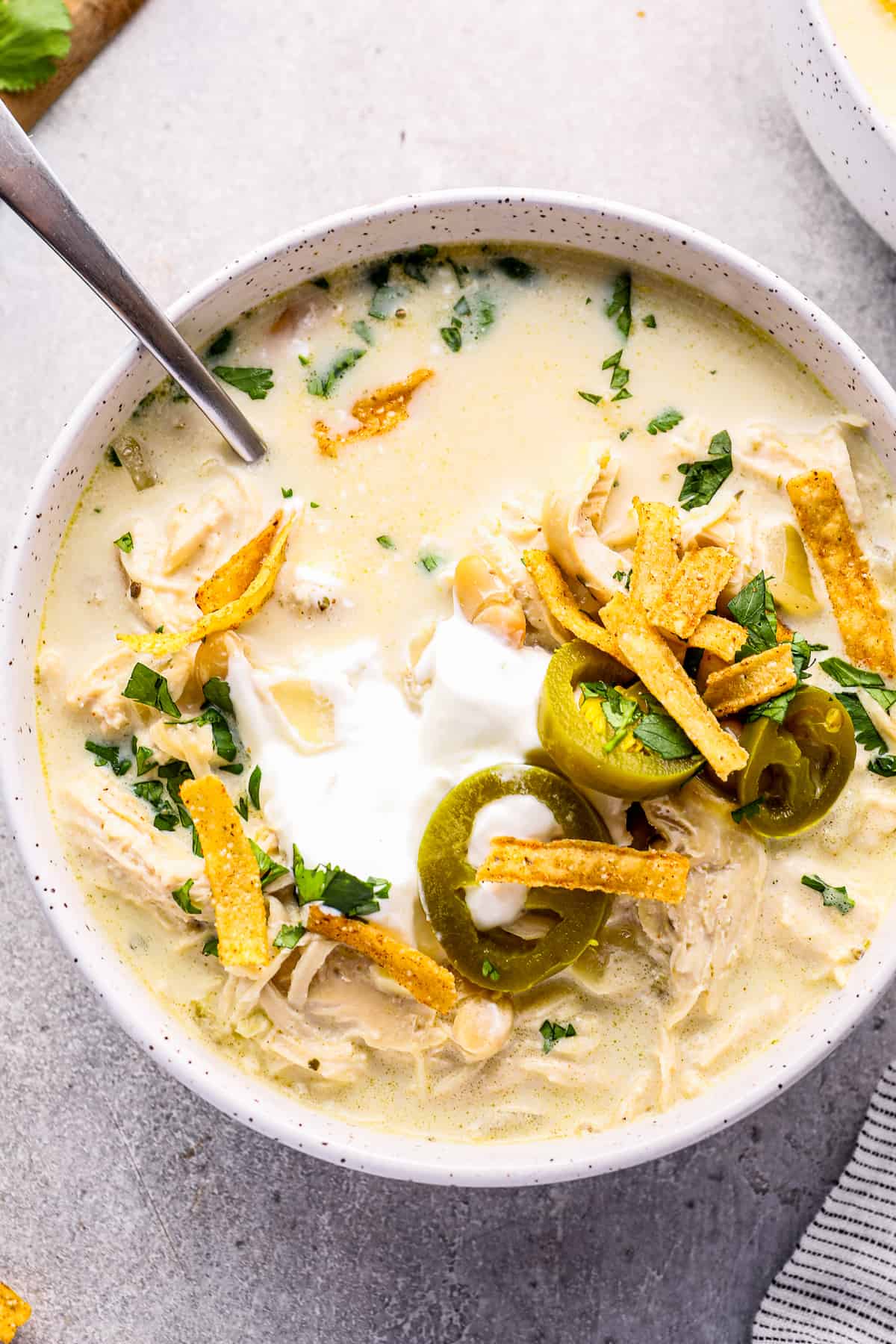 bowl of crockpot white chicken chili with spoon