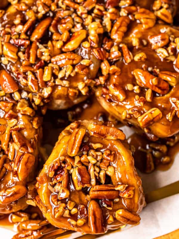 caramel pecan sticky buns on a white serving tray