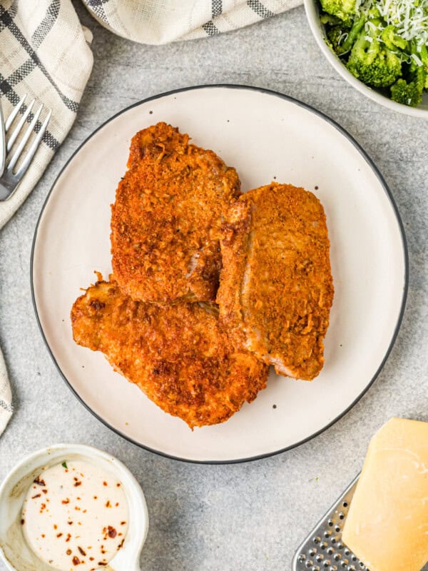 cooked pork chops on a white plate