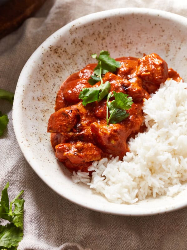 white bowl with chicken tikka masala and rice