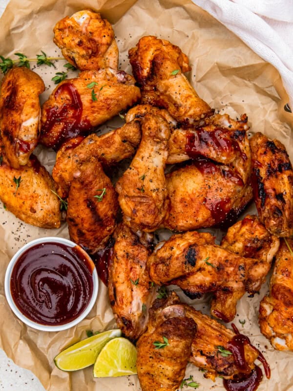 grilled chicken wings with dipping sauce in a small bowl