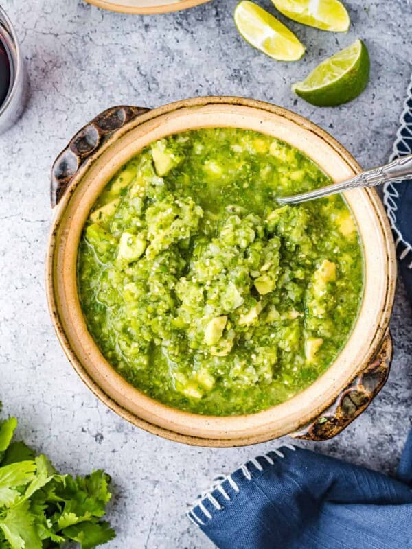 tomatillo avocado salsa in a bowl with a spoon