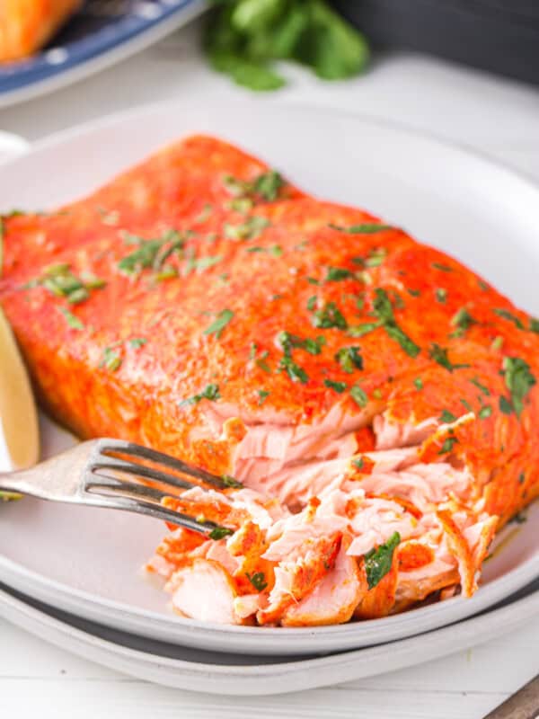 cilantro lime salmon on a white plate with a fork