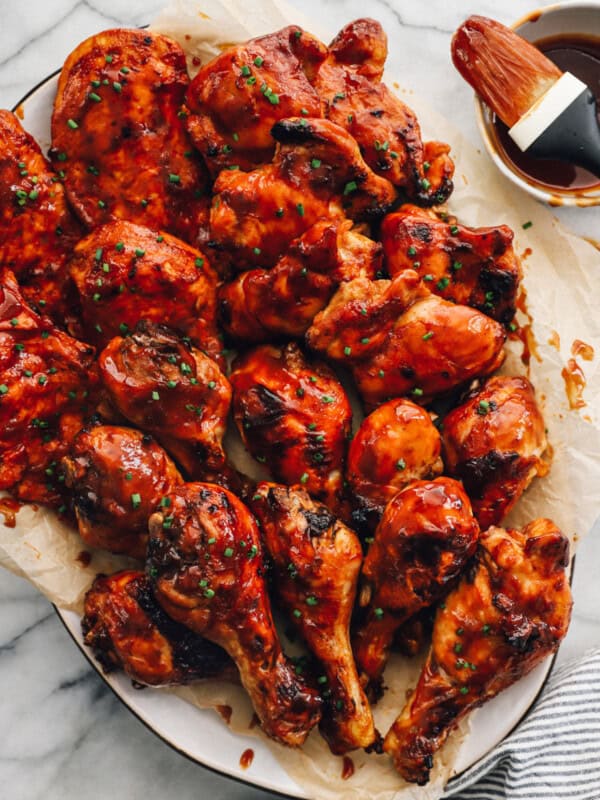 baked bbq chicken breasts, thighs, and drumsticks on a serving platter