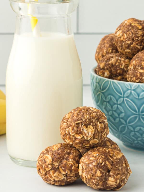 banana bread protein balls with a glass of milk with a straw