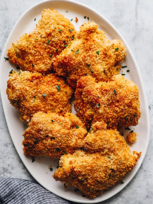 baked chicken thighs on a white serving plate