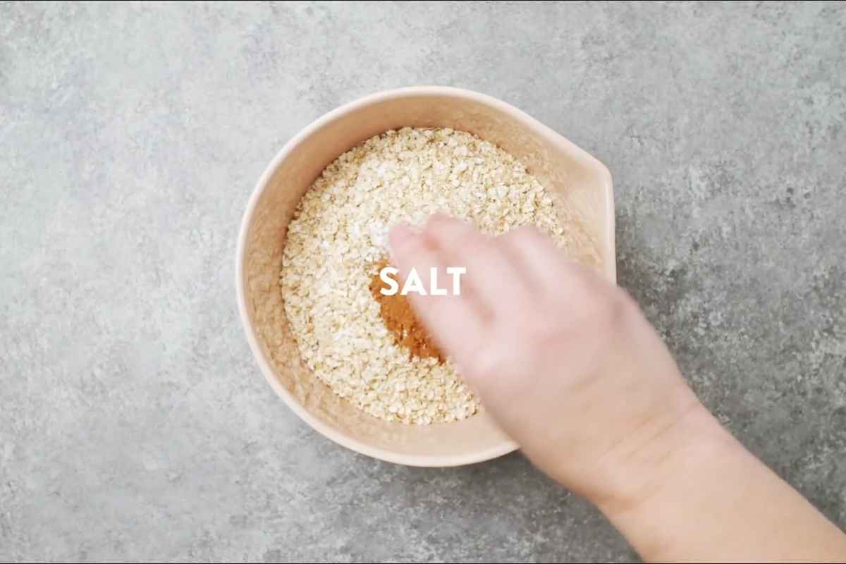 mixing dry ingredients for breakfast cookies in a glass bowl.