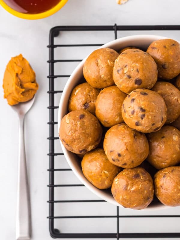 overhead image of chocolate peanut butter protein balls in a white bowl