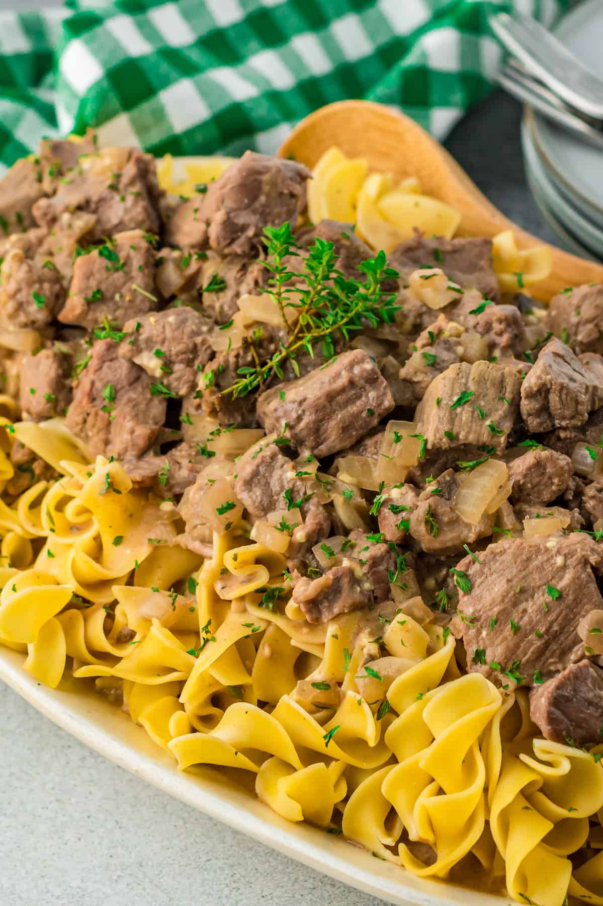 beef and noodles on a white serving platter