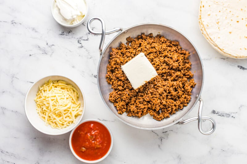 cream cheese added to ground beef in a saucepan